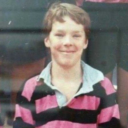 Young Benedict Cumberbatch seats on a chair while posing for a picture